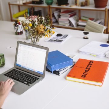 Person at desk with computer open